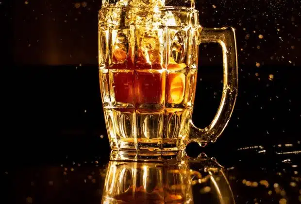 clear glass mug with brown liquid