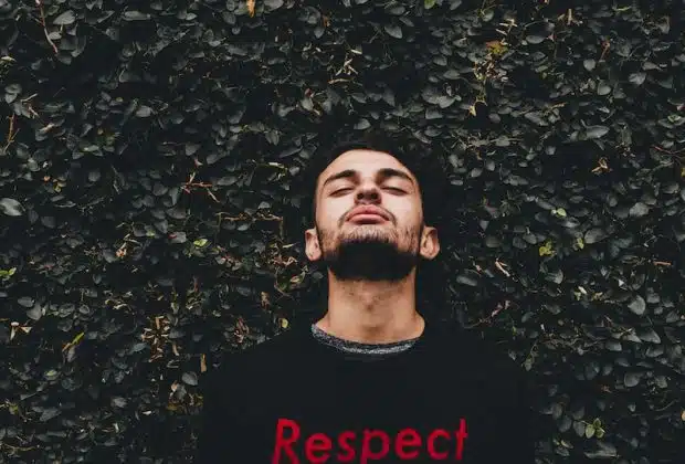 man leaning on plant wall